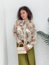Blusa astratta con spilla fiore